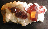 Clear cinnabar crystals on calcite (4 cm), China